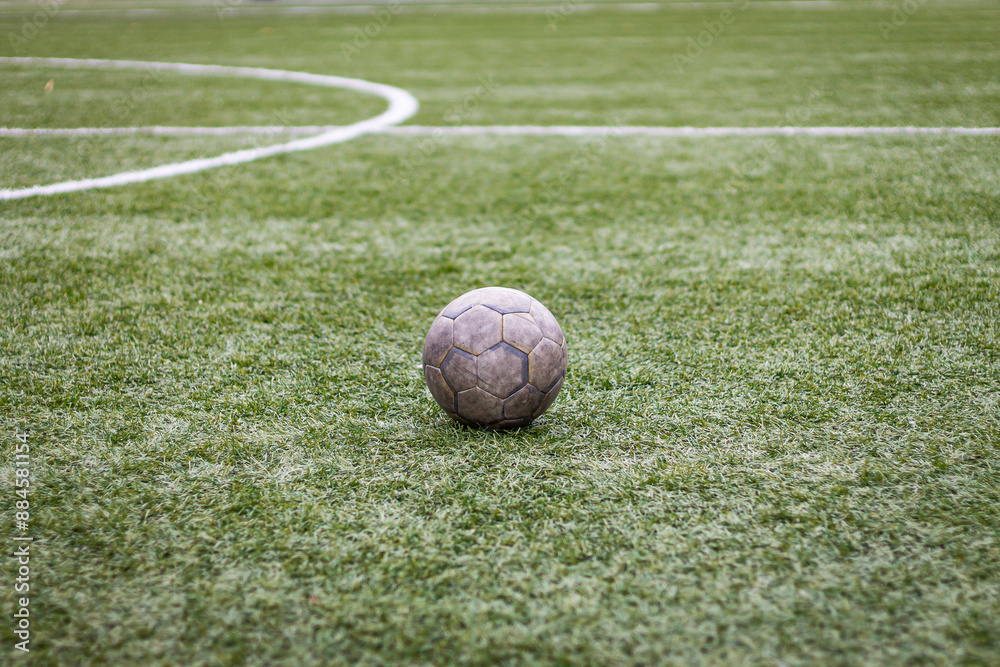 Old dirty ball on green soccer field.
Team sport, football match at the stadium Old dirty ball on green soccer field.
Team sport, football match at the stadium