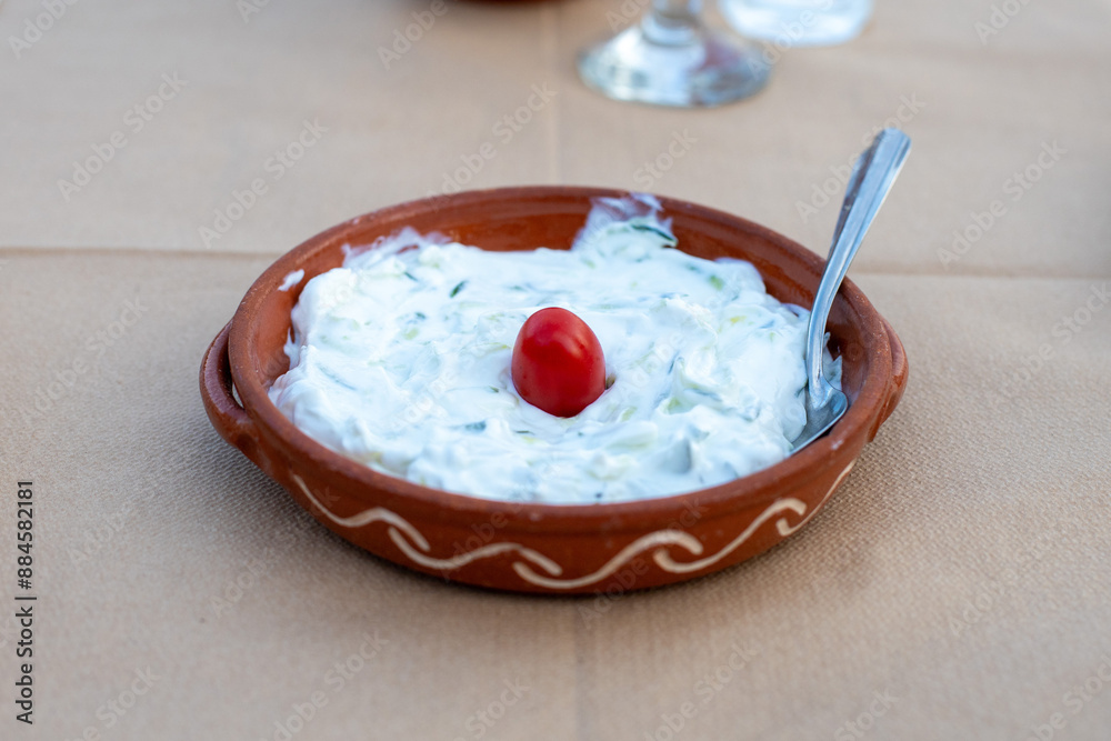 Traditional greek tzatziki dip with cucumber and tomato Traditional greek tzatziki dip with cucumber and tomato