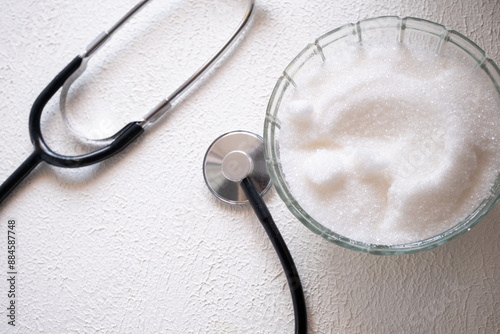 stethoscope and granulated sugar on a white background photo