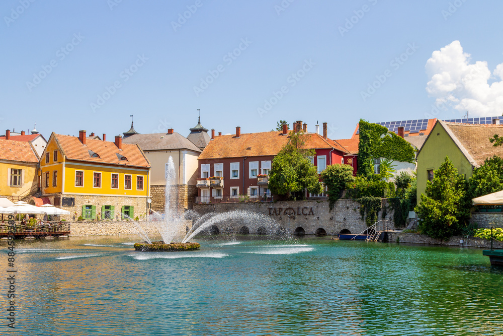 Obraz premium A town of Tapolca in Balaton region of Hungary with lake in the middle of the city and fountain, carps in the lake
