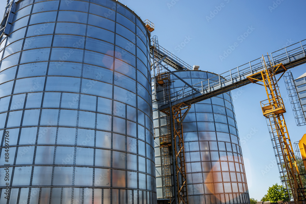 Fototapeta premium silos on agro-industrial complex with seed cleaning and drying line for grain storage. Granary elevator