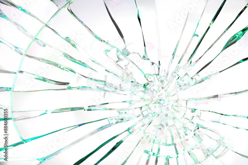 A shattered glass window with a green tint