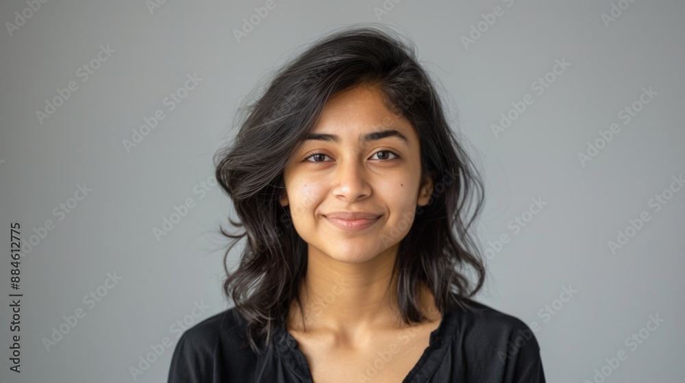 Portrait of a young smiling woman with dark hair and casual attire against a neutral background. Perfect for use in blogs, articles, or promotional materials. Captures a natural look. AI Portrait of a young smiling woman with dark hair and casual attire against a neutral background. Perfect for use in blogs, articles, or promotional materials. Captures a natural look. AI