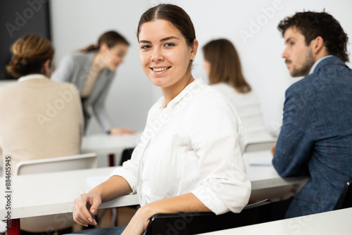 Billede på lærred Cheerful woman turning around and looking at camera during advanced training cou