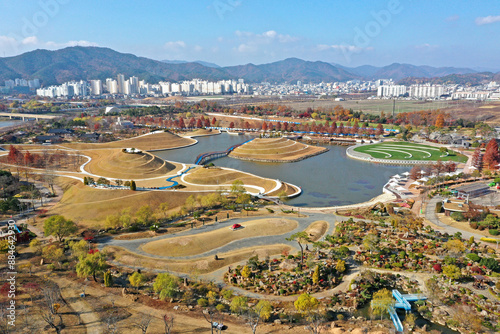 Pungdeok-dong, Suncheon-si, Jeollanam-do, South Korea - November 23, 2022: Aerial and autumnal view of Suncheon Bay National Garden with trail and pond at Suncheon Bay
 photo