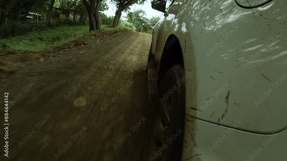 Point of view angle of SUV truck driving off-road and  kicking up mud 
