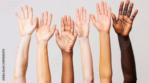 A series of six raised arms and hands of varying skin tones against a light-colored background, symbolizing unity, diversity, and inclusion among different races.
