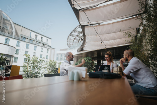 Young business entrepreneurs strategize and collaborate on a project at an outdoor meeting for improvement and growth of their business. photo