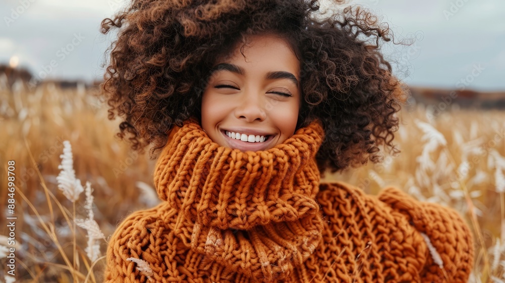 Happy woman with a joyful smile looking warmly at the camera against a soft, blurred background