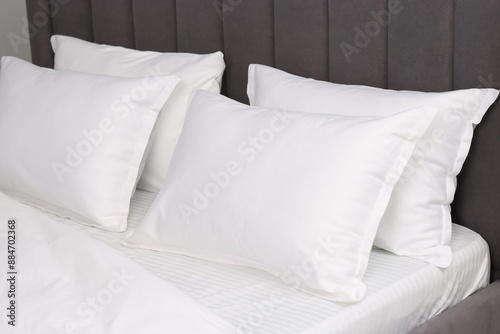 Many soft pillows on bed at home, closeup