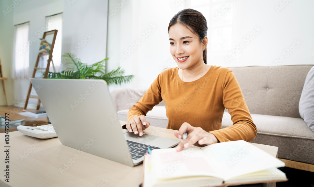 Happy positive cute beautiful business woman sit indoors at home using laptop computer. Happy positive cute beautiful business woman sit indoors at home using laptop computer.