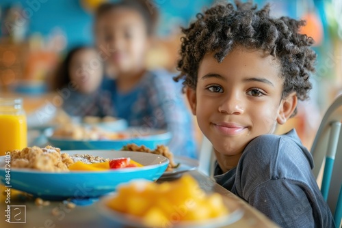 A student kid sits at the breakfast table enjoying a nutritious meal before heading to school The table is set with healthy options like fruits and cereals, and the child eats eagerly Parents can be