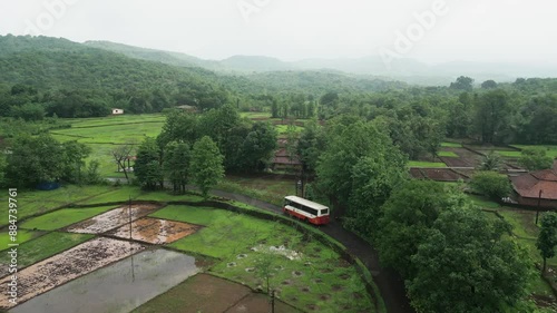 state transport bus going in forest in rainey season drone view in konkan photo