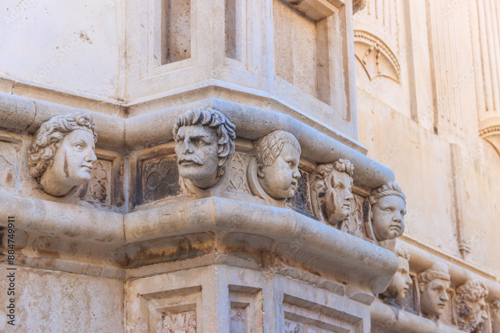 Stone heads on the side portal of The Cathedral of St. James in Sibenik, Croatia. Details of Sibenik Cathedral Stone heads on the side portal of The Cathedral of St. James in Sibenik, Croatia. Details of Sibenik Cathedral
