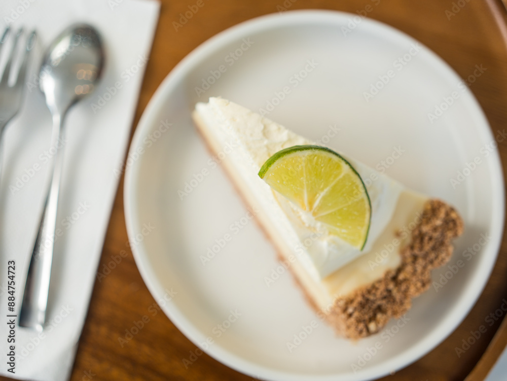 Slice of lemon cheesecake on white dish. Slice of lemon cheesecake on white dish.
