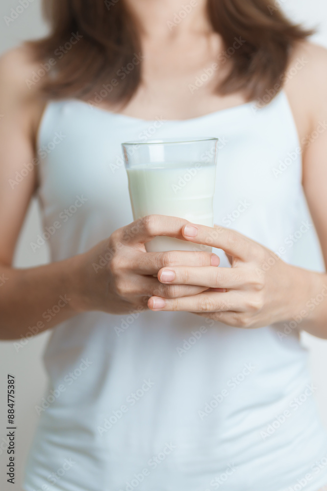 Milk drink and Daily Routine concept. Young woman Drinking milk with high calcium and nutrition at home, woman holding soy milk on glass with protein. Healthy, wellness and happy lifestyle Milk drink and Daily Routine concept. Young woman Drinking milk with high calcium and nutrition at home, woman holding soy milk on glass with protein. Healthy, wellness and happy lifestyle