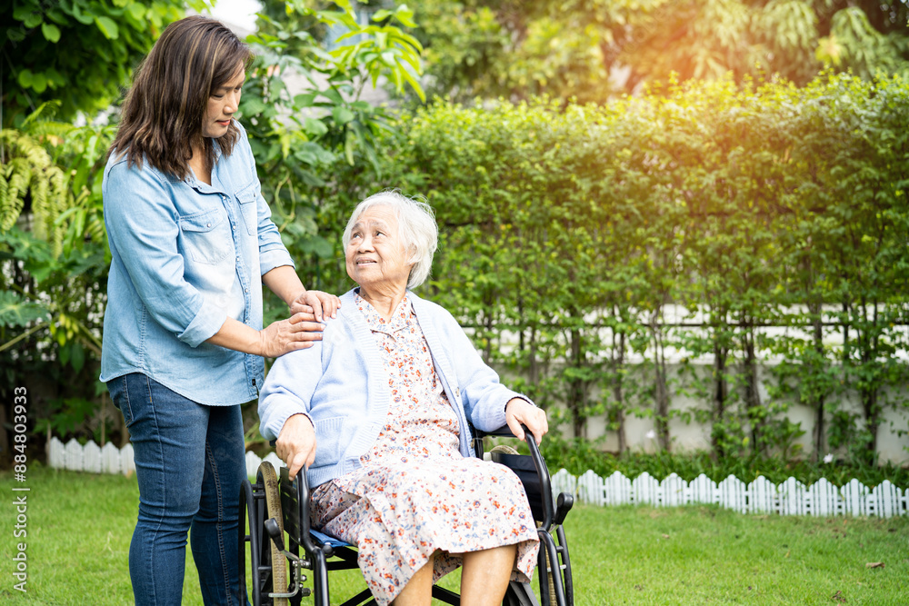 Caregiver help and care Asian senior woman patient sitting on wheelchair at nursing hospital ward, healthy strong medical. Caregiver help and care Asian senior woman patient sitting on wheelchair at nursing hospital ward, healthy strong medical.