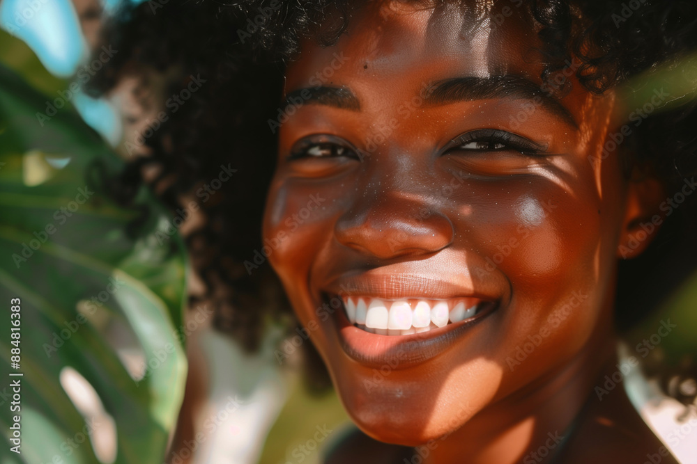 woman with curly hair is smiling and looking at the camera. She has a bright, sunny look on her face woman with curly hair is smiling and looking at the camera. She has a bright, sunny look on her face