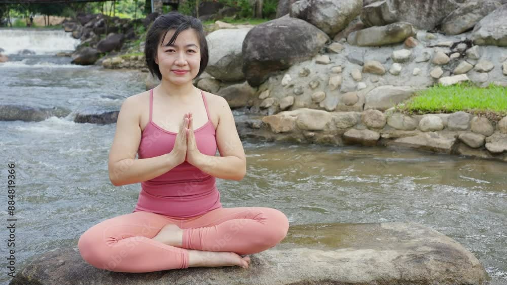 Asian woman in sportswear practicing yoga exercise on the rock at natural park. People enjoy healthy outdoor lifestyle with nature do sport training fitness workout yoga and meditation in the garden. Asian woman in sportswear practicing yoga exercise on the rock at natural park. People enjoy healthy outdoor lifestyle with nature do sport training fitness workout yoga and meditation in the garden.