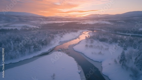 Aerial view of a snowy landscape in winter, with a forest and river at sunset in Lapland, Finnish and Swedish mountains, with lake district scenery in a Scandinavian northern nature landscape, sky, ho photo