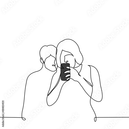 woman stands immersed in the screen of her phone and a man peeks from behind - one line art vector. concept of peeking into someone else's phone, spying and checking your partner