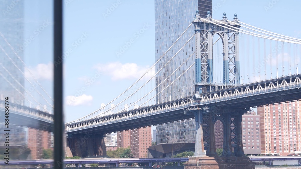 Obraz premium New York City Manhattan Bridge, Brooklyn waterfront, United States. Dumbo riverfront promenade by water, East river. USA travel destination. Cable-stayed bridge, riverside park, residential buildings.