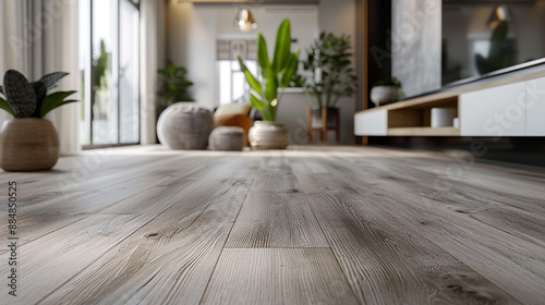 A contemporary living room featuring light grey vinyl flooring with a subtle wood grain texture, providing a sleek and durable surface.