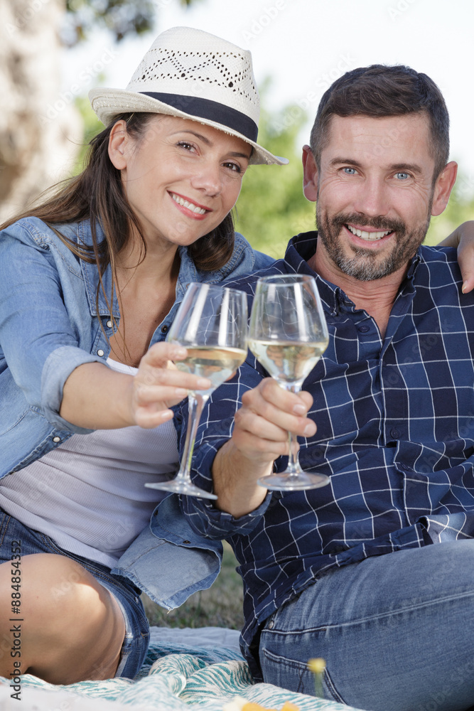 cute couple drinking wine on a picnic cute couple drinking wine on a picnic