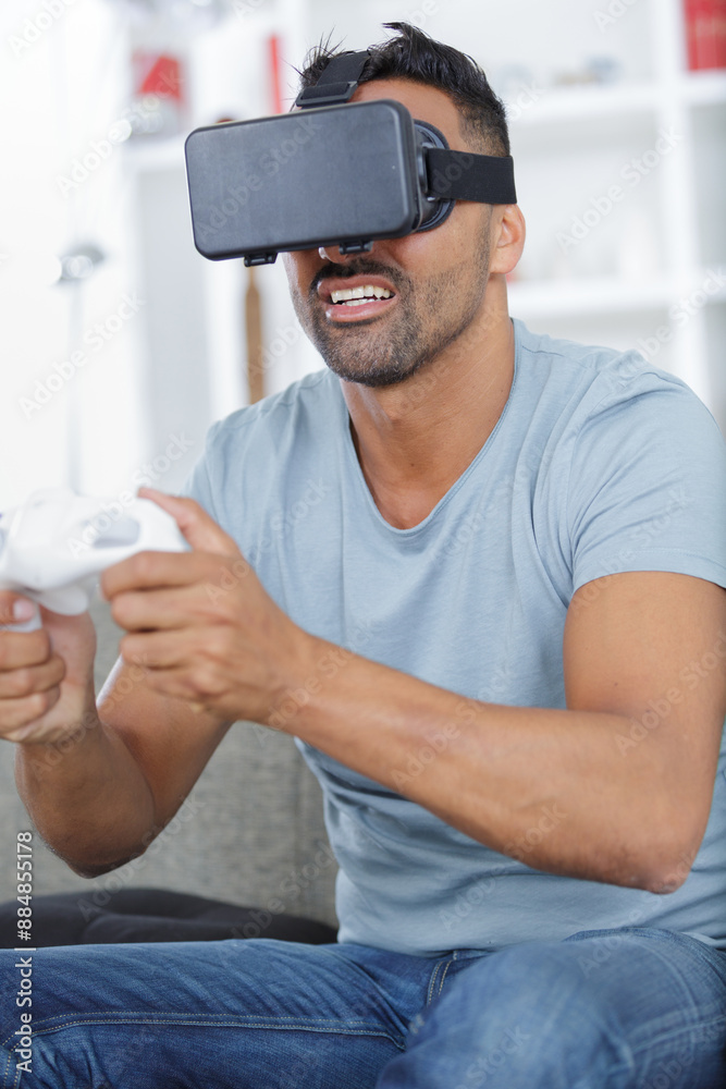young man wearing vr headset and experiencing virtual reality young man wearing vr headset and experiencing virtual reality