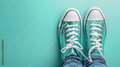 Sparkly green sneakers on a teal background