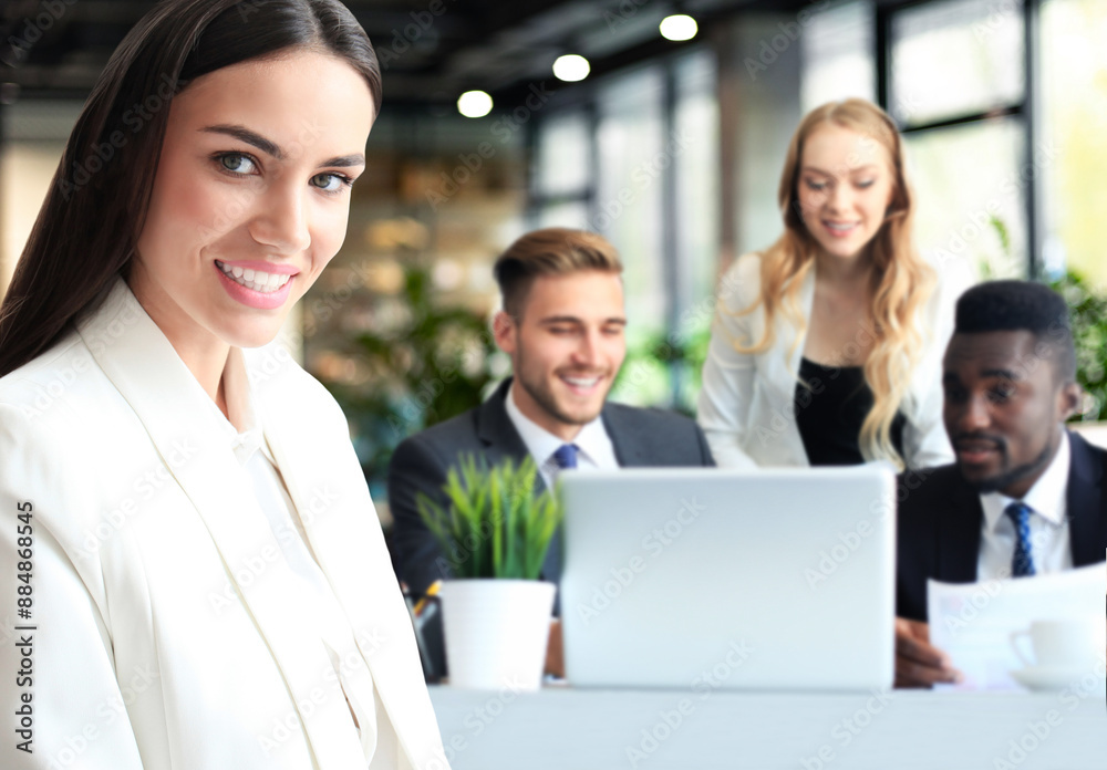 Businessman with colleagues in the background in office. Businessman with colleagues in the background in office.