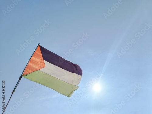 The Palestinian flag flies in the blue sky. photo