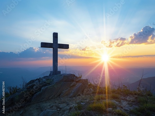 The Christian cross illuminated by a heavenly light against a backdrop of dawn or dusk photo