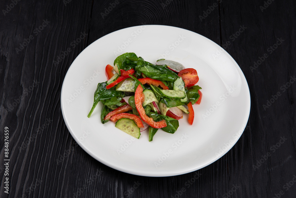 Fresh vegetable salad of cucumbers, tomatoes, raddish, bell pepper, basil and olive oil. Fresh vegetable salad of cucumbers, tomatoes, raddish, bell pepper, basil and olive oil.