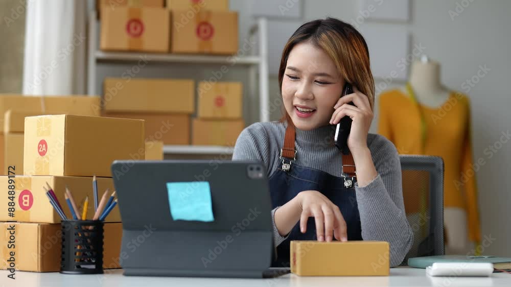 SME entrepreneur Small business entrepreneurs Online selling ideas,Happy Young Asian business owner work on computer and a boxs at home,delivery SME procurement package box deliver to customers. SME entrepreneur Small business entrepreneurs Online selling ideas,Happy Young Asian business owner work on computer and a boxs at home,delivery SME procurement package box deliver to customers.