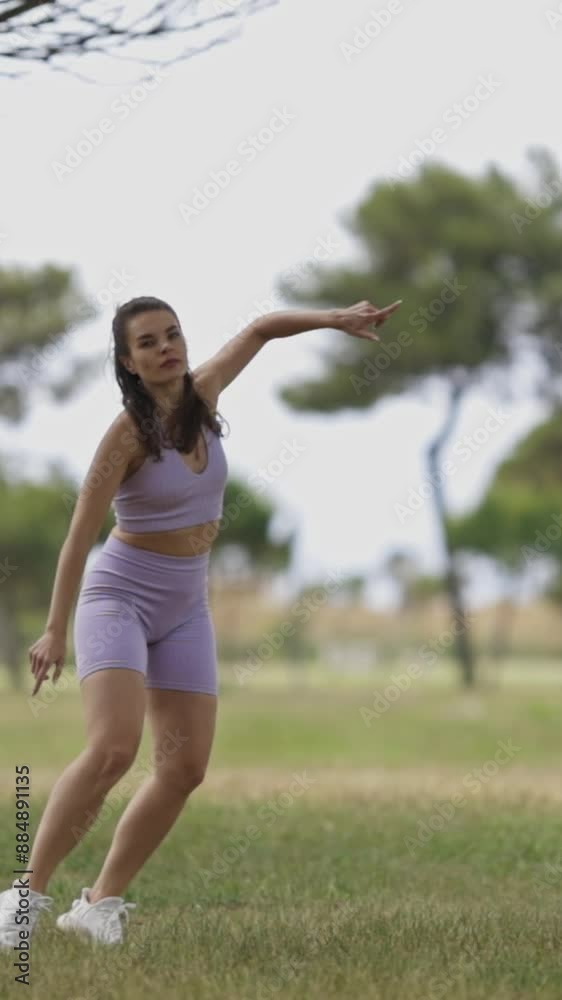 A woman is make sportive dance in the park A woman is make sportive dance in the park