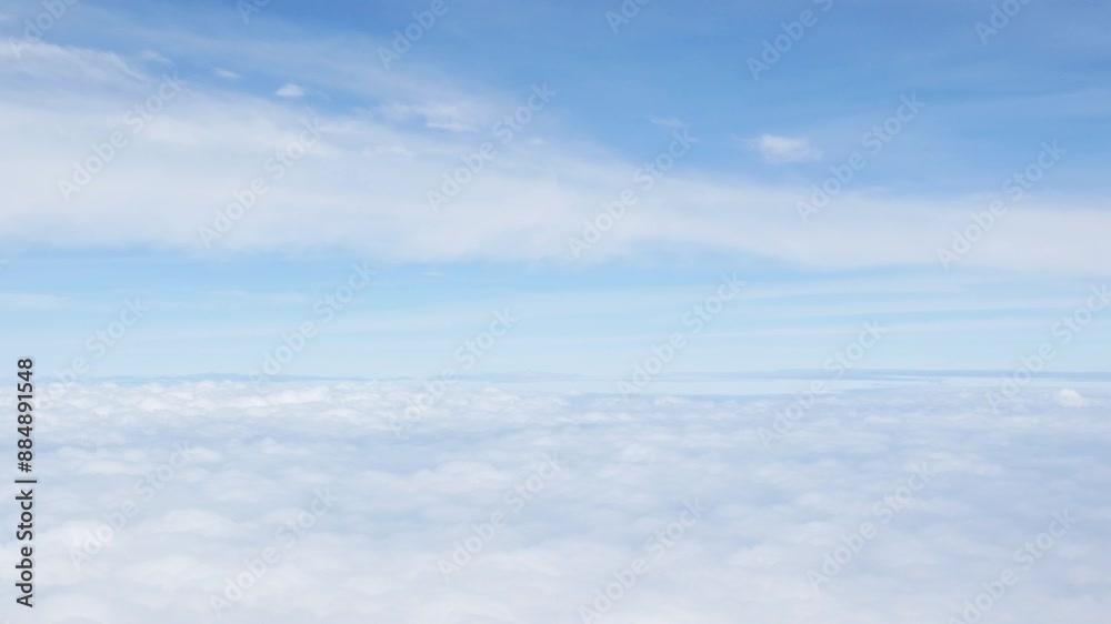 Aerial view above the clouds and sky inspiration concept in cinematic breathtaking aerial flying over white fluffy cloudscape in high altitude sky with fresh clean air and blue skies on background. Aerial view above the clouds and sky inspiration concept in cinematic breathtaking aerial flying over white fluffy cloudscape in high altitude sky with fresh clean air and blue skies on background.