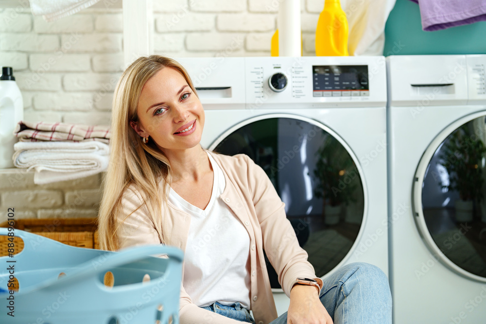 Woman Leaning On Washing Machine In Laundry Room Woman Leaning On Washing Machine In Laundry Room