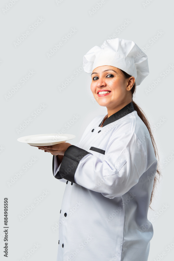 Indian asian Female Chef Pointing to Blank Plate - Professional Cook Indian asian Female Chef Pointing to Blank Plate - Professional Cook