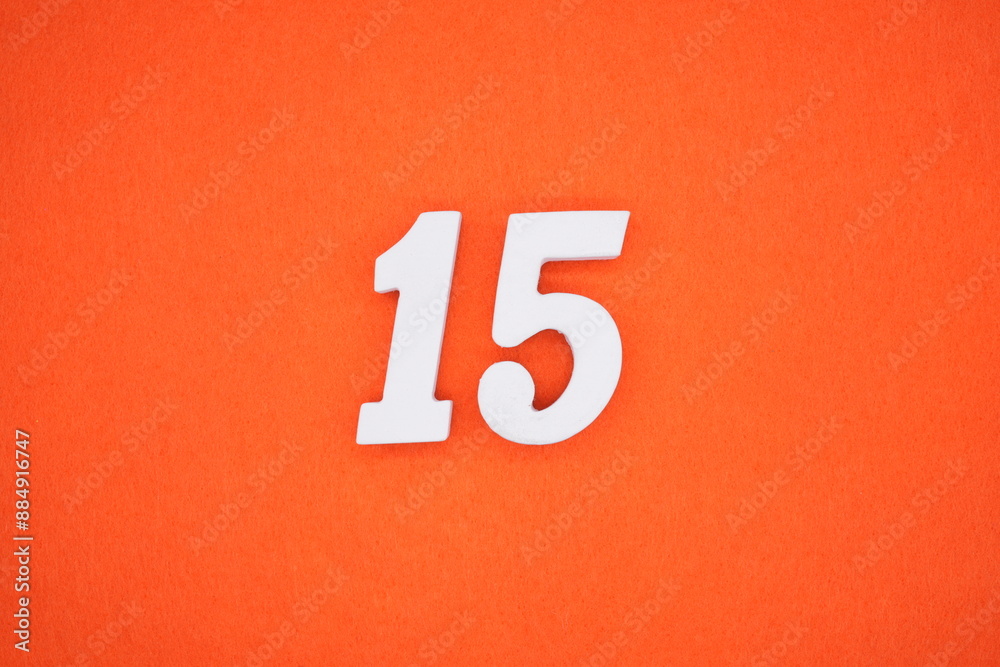 The numbers are made of white painted wood. Placed on the floor was orange paper. The numbers are made of white painted wood. Placed on the floor was orange paper.