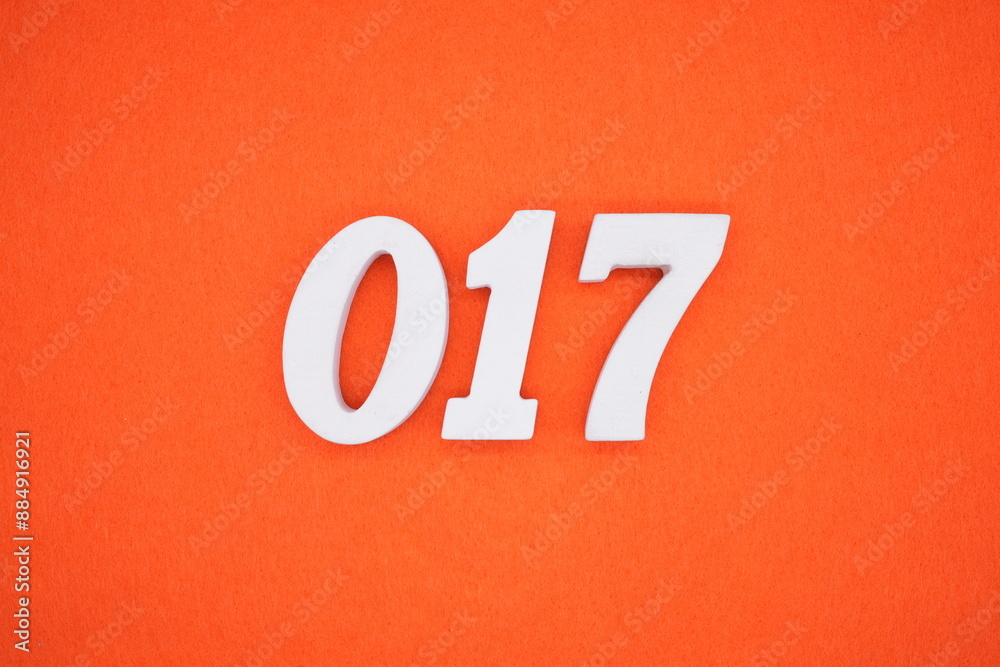 The numbers are made of white painted wood. Placed on the floor was orange paper. The numbers are made of white painted wood. Placed on the floor was orange paper.
