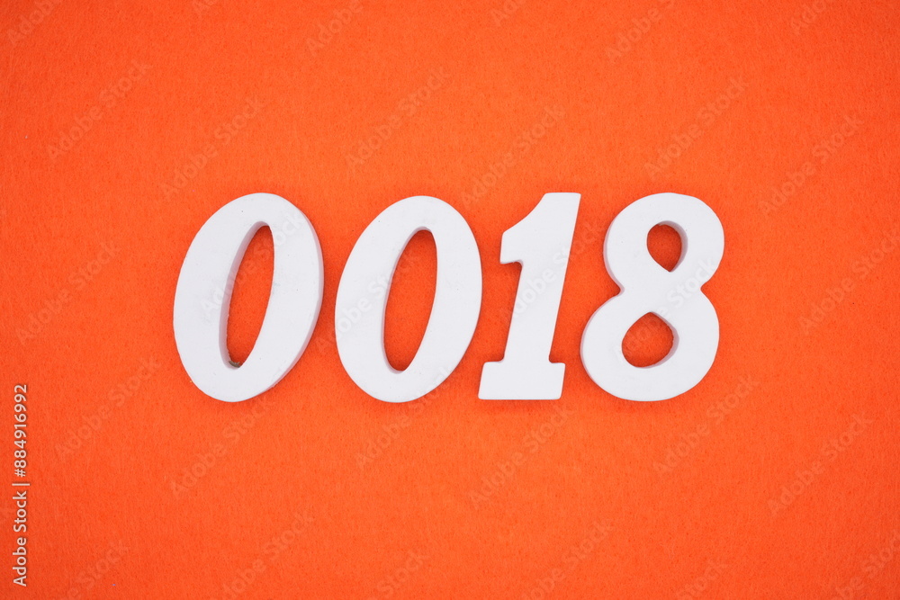 The numbers are made of white painted wood. Placed on the floor was orange paper. The numbers are made of white painted wood. Placed on the floor was orange paper.