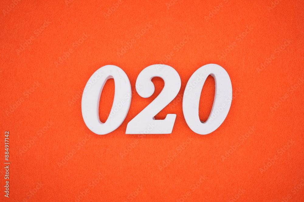 The numbers are made of white painted wood. Placed on the floor was orange paper. The numbers are made of white painted wood. Placed on the floor was orange paper.