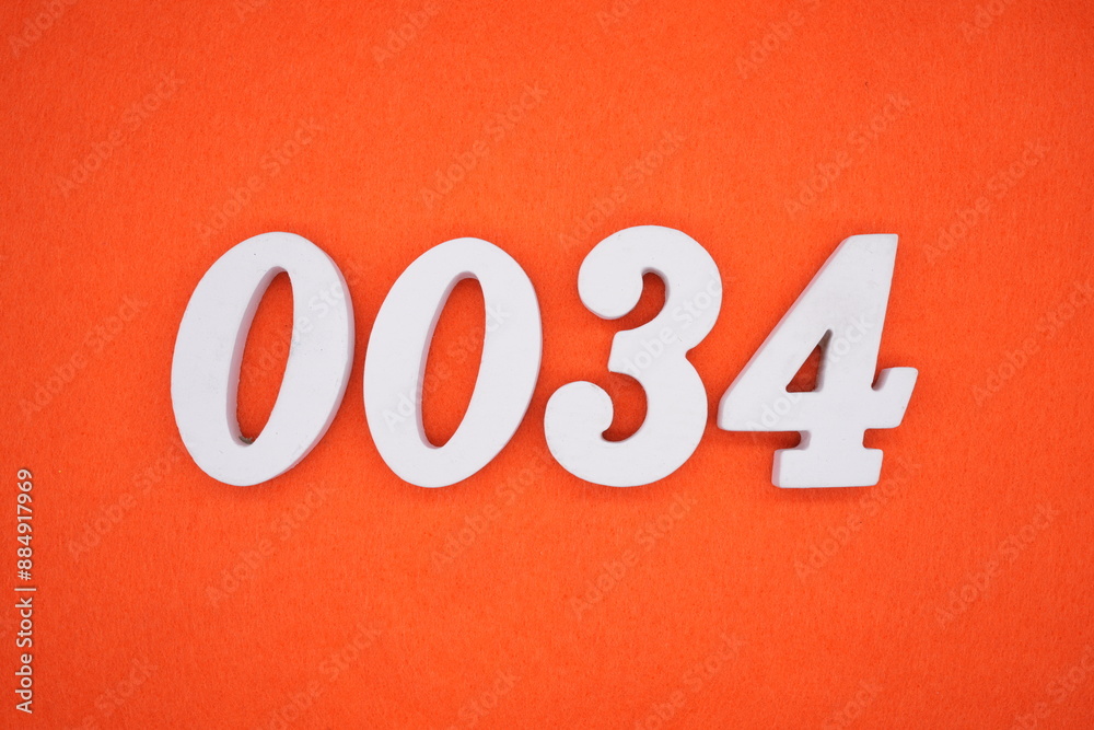 The numbers are made of white painted wood. Placed on the floor was orange paper. The numbers are made of white painted wood. Placed on the floor was orange paper.