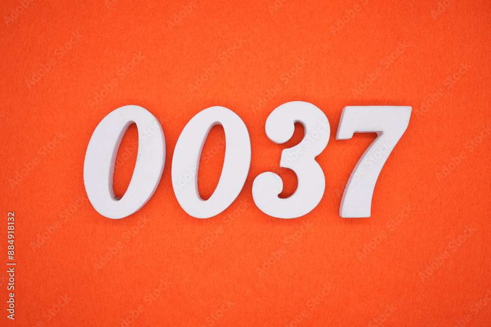 The numbers are made of white painted wood. Placed on the floor was orange paper. The numbers are made of white painted wood. Placed on the floor was orange paper.