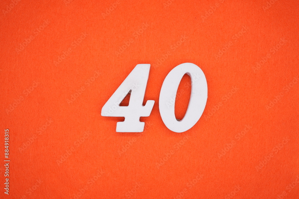 The numbers are made of white painted wood. Placed on the floor was orange paper. The numbers are made of white painted wood. Placed on the floor was orange paper.