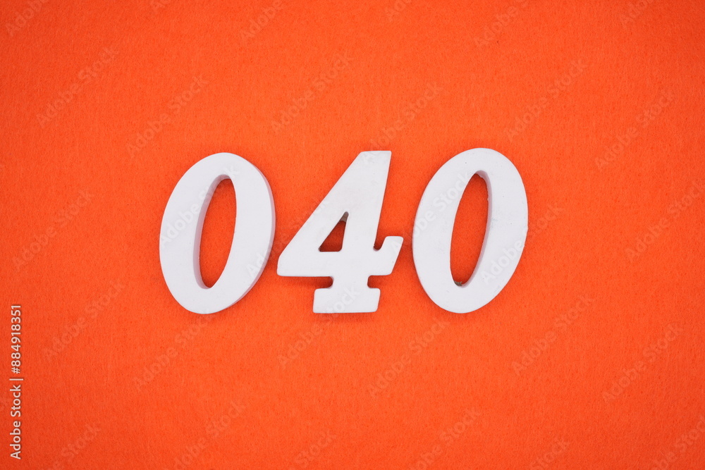 The numbers are made of white painted wood. Placed on the floor was orange paper. The numbers are made of white painted wood. Placed on the floor was orange paper.