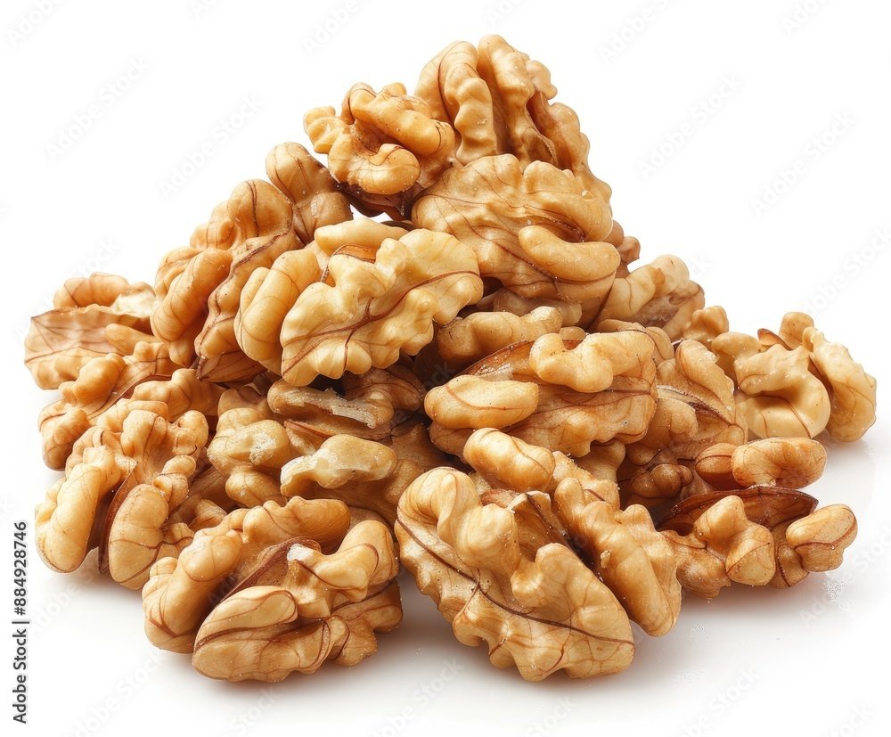 Close-up of walnuts scattered on a white surface. Close-up of walnuts scattered on a white surface.
