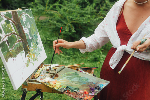 Female artis paints a picture in the park. Mindfulness, art therapy, creativity concept. Process of plein air painting in nature. A series of photos showing the step-by-step creation of a painting photo