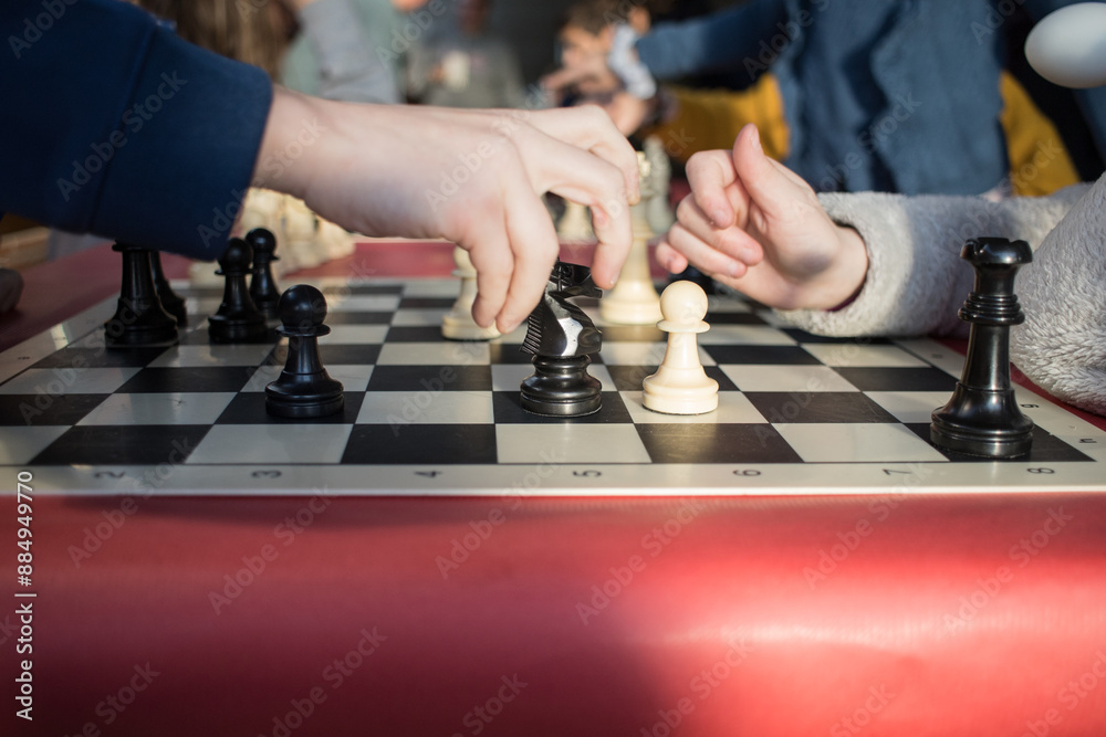 hands children playing chess. move piece in chessboard. strategy intelligence thinking. horizontal hands children playing chess. move piece in chessboard. strategy intelligence thinking. horizontal